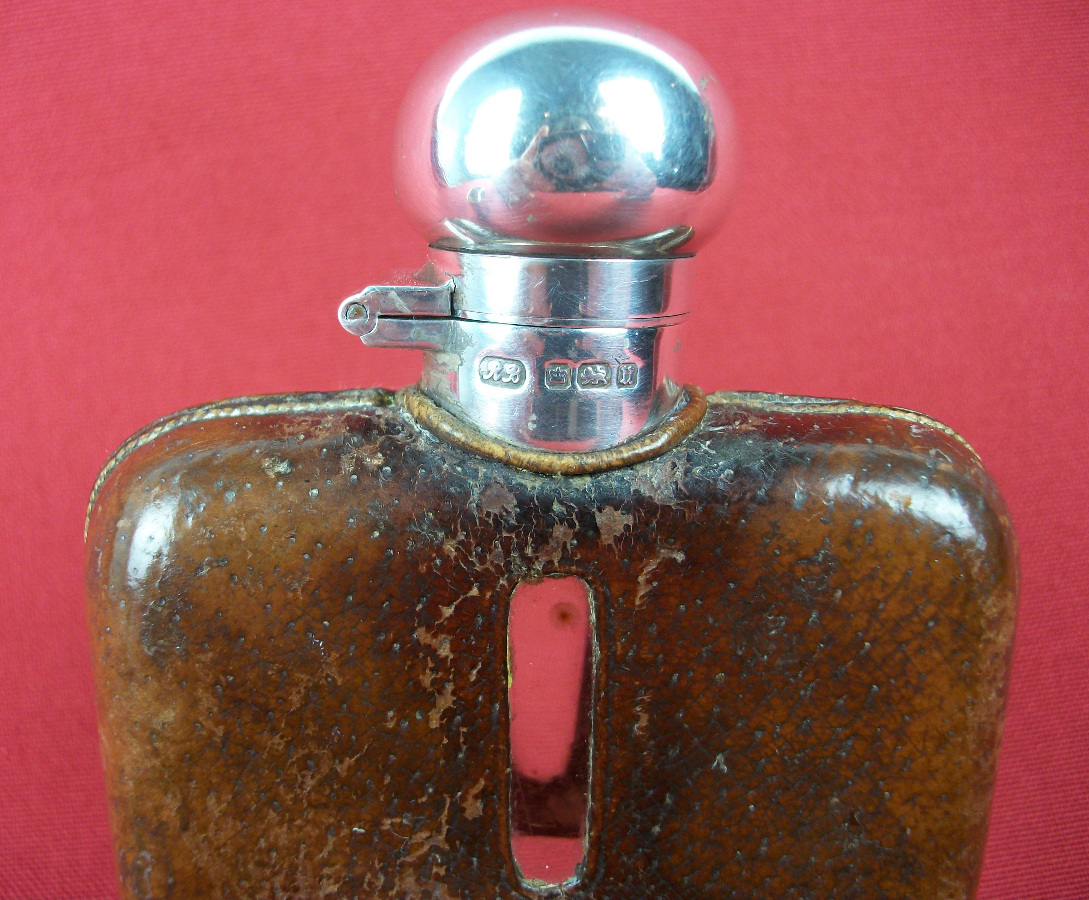 silver and leather bound hip flask